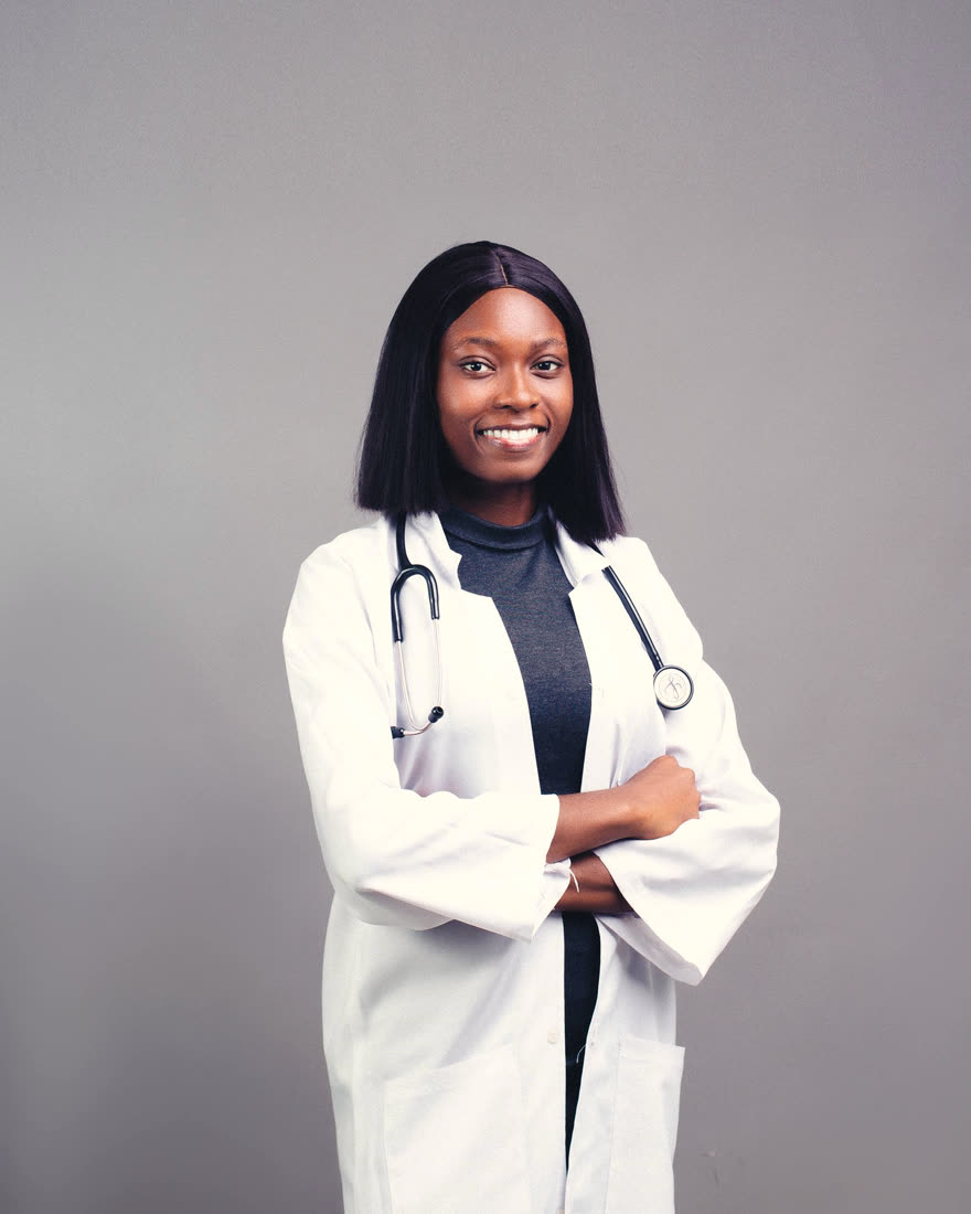 Portrait of Dr. Miriam Okafor, physician, in a white coat with a stethoscope
